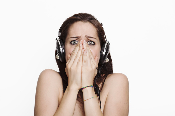 Scared girl listening to music - Photo, image