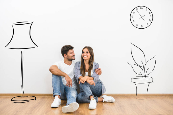 The man and woman sit near the wall with illustrations - Photo, Image