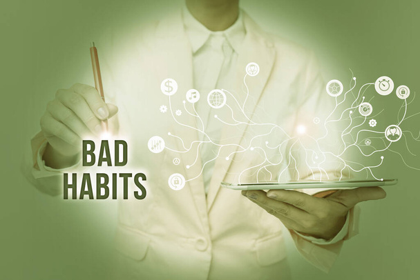 Conceptual caption Bad Habits. Business showcase the uncontrollable negative habitual behavioral pattern of a person Lady In Uniform Standing And Holding Tablet Showing Futuristic Technology. - Photo, Image