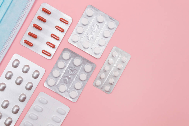 Different Pills and Tablets Package on Pink Background - Foto, imagen