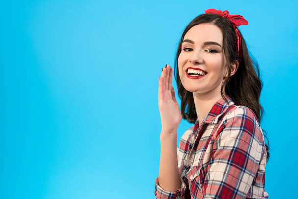 The happy girl gesturing on the blue background - Fotó, kép