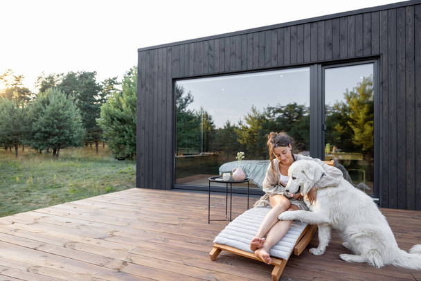 Mujer disfrutar de la naturaleza en casa de campo con mascota - Foto, imagen