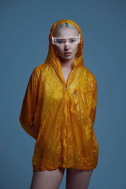 Futuristic woman in raincoat and modern glasses - Zdjęcie, obraz