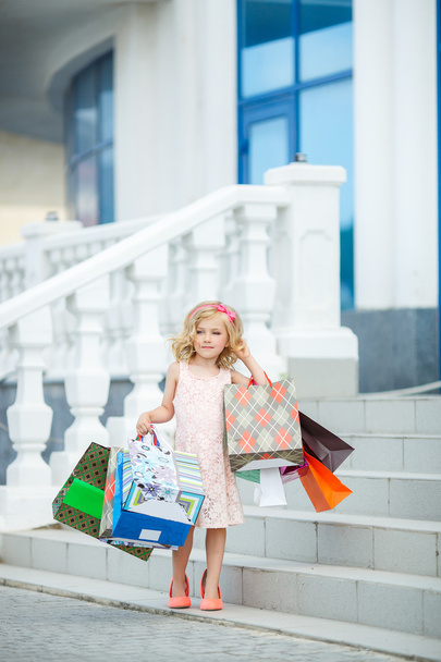 Fun preschool girl walking with bags. - Foto, Imagen