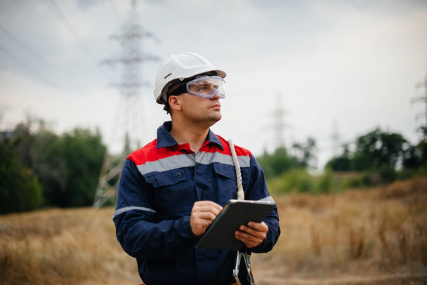 An energy worker inspects power lines. Energy - Valokuva, kuva