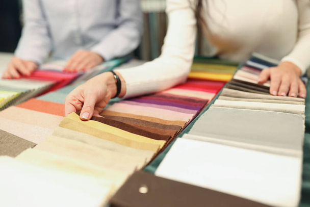 Buyer and seller choose color of fabric closeup - Фото, зображення