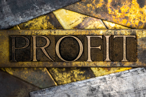 Profit text on textured grunge copper and vintage gold background - Photo, Image