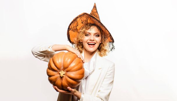 Smiling Woman in Witch hat with pumpkin. Halloween concept. - Photo, Image