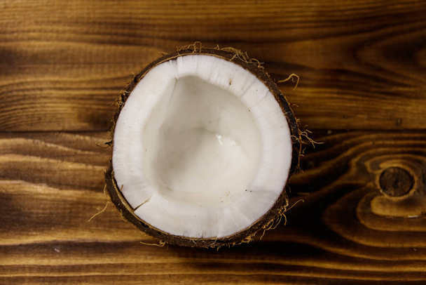 Fresh ripe coconut on rustic wooden table. Top view - 写真・画像