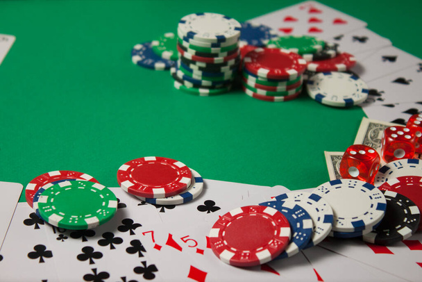 Classic playing cards, chips, red dice and dollars on green background. Gambling and casino concept. - Foto, Bild