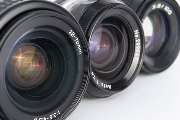 Modern and old DSLR camera lens set on white background close-up - Photo, Image