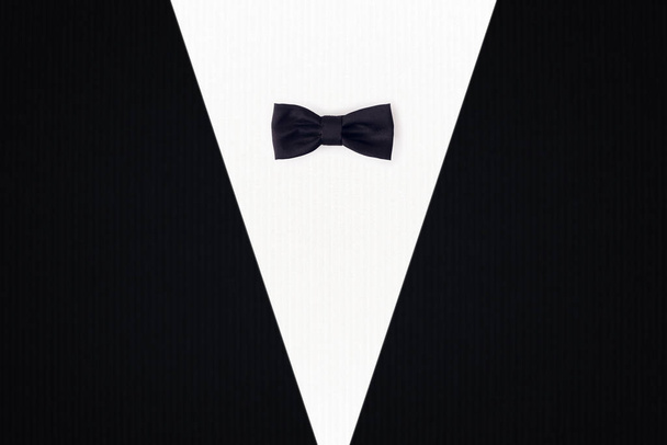 Black bowtie on black and white background. Minimal concept and design. - Photo, Image