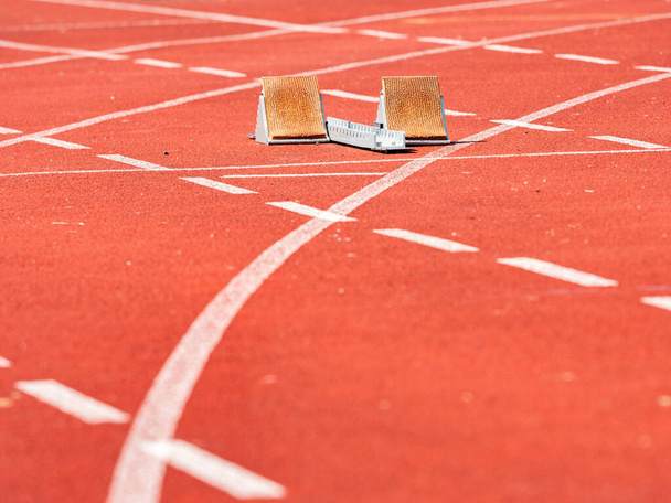 Empty Starting Blocks and red running tracks in a stadion. Athletic training - Photo, Image