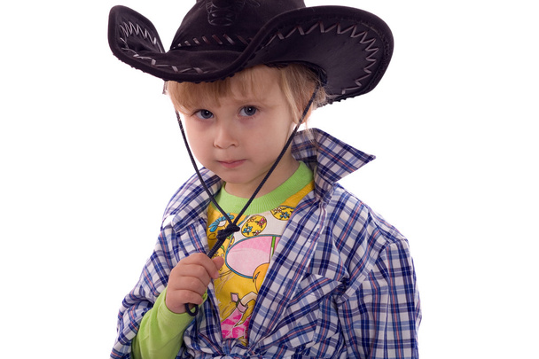 Child in a cowboy hat and plaid shirt. Isolated on white. - Fotoğraf, Görsel