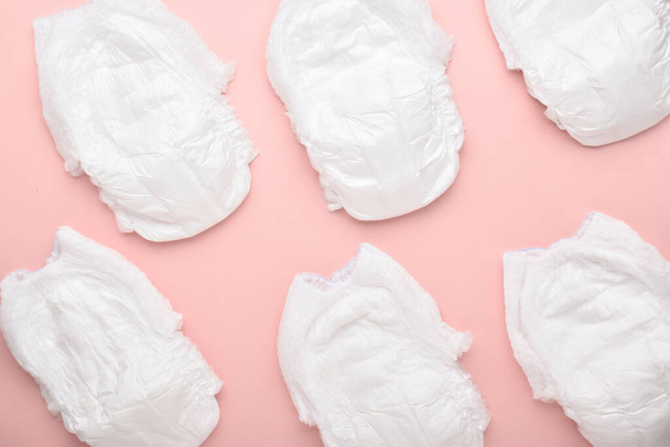 Background of diapers-panties on a pink background. Top view, copy space. - Fotoğraf, Görsel