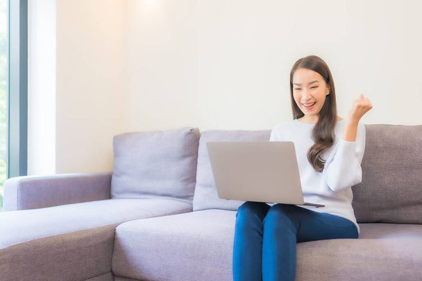 Portrait beautiful young asian woman use laptop for working in living room - Photo, Image