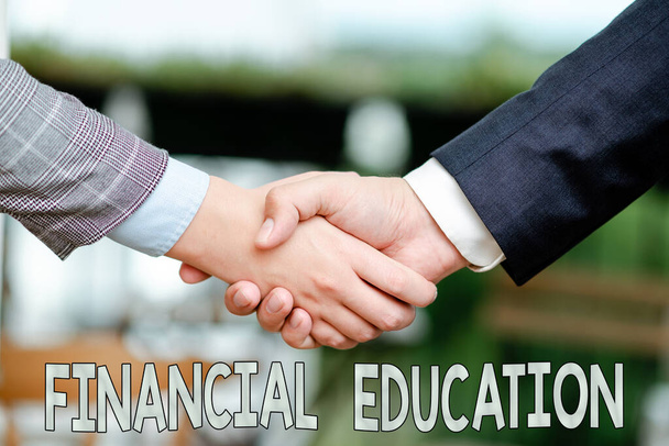 Handwriting text Financial Education. Business concept education and understanding of various financial areas Two Professional Well-Dressed Corporate Businessmen Handshake Indoors - Zdjęcie, obraz