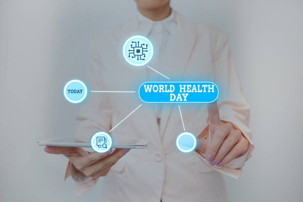 Inspiráció, ami az Egészségügyi Világnap jeleit mutatja. Minden évben április 7-én ünnepeljük a globális egészségtudatosság napjára írt szót Lady Holding Tablet Pressing On Virtual Button Showing Futuristic Tech. - Fotó, kép