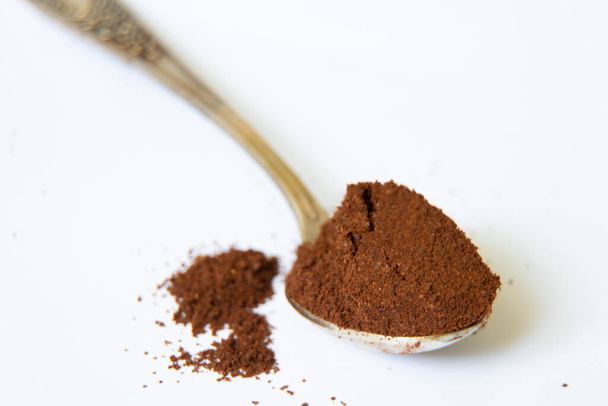 a spoonful of ground coffee on a white background close up - Photo, Image
