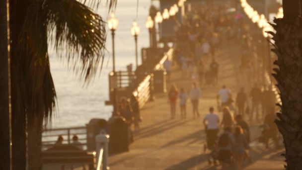 People walking, wooden pier in California USA. Oceanside waterfront vacations tourist resort. - Photo, Image