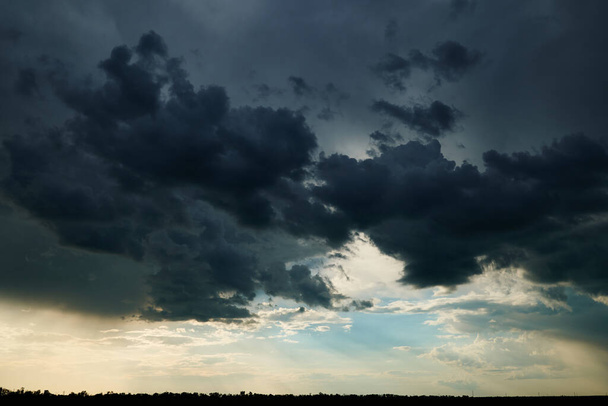 beautiful dark dramatic sky with sunlight and clouds as a background - Photo, Image
