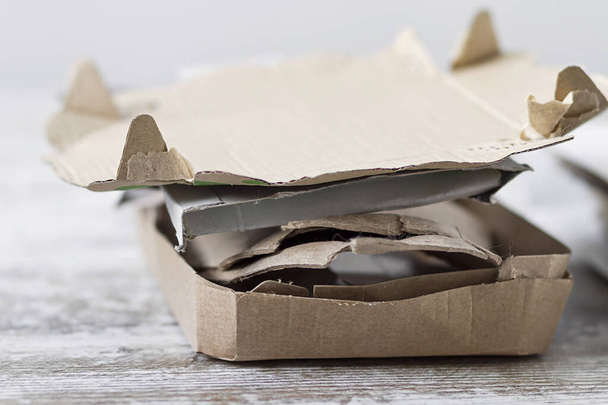 Cardboard scraps from a home stacked to be recycled - Фото, изображение
