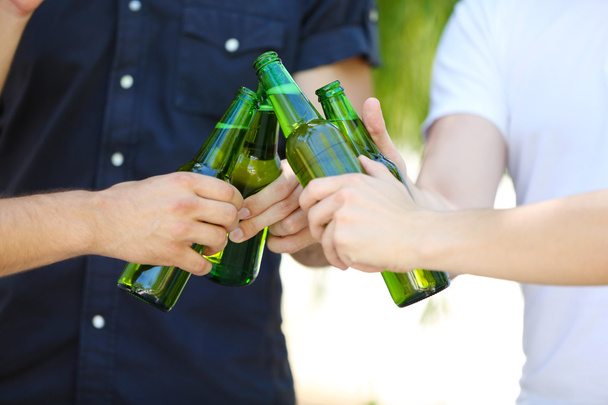 Hands holding beer bottles close up - Фото, зображення