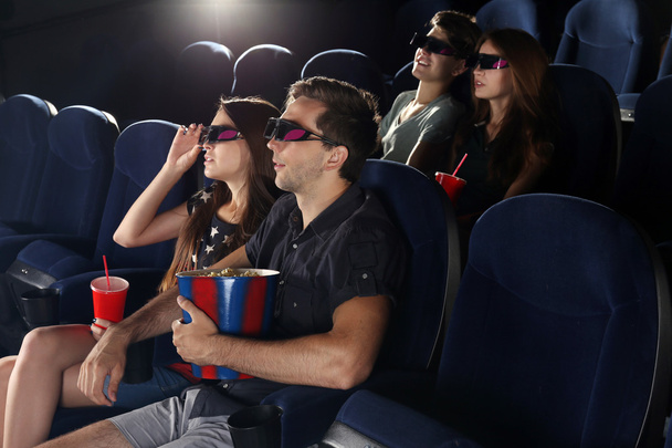 Young people watching movie in cinema - 写真・画像