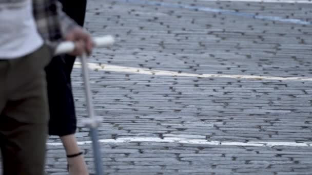 Paving stones on the square on which people are walking. - Video, Çekim