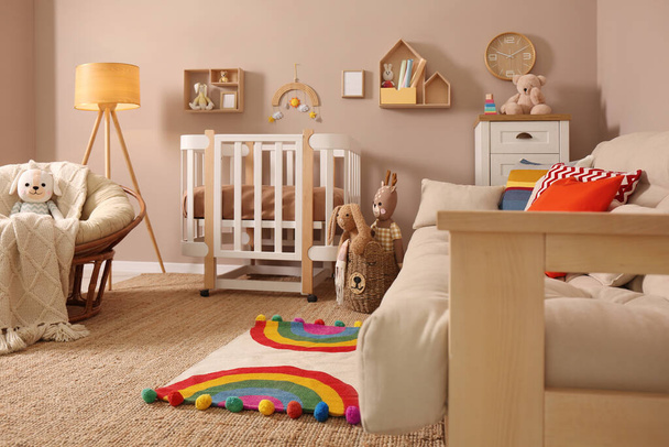 Baby room interior with stylish furniture and comfortable crib - Foto, Imagen