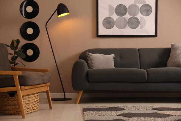 Stylish living room interior with comfortable dark sofa - Photo, Image