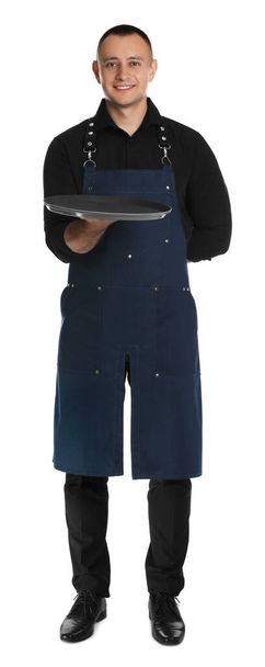 Full length portrait of happy young waiter with tray on white background - Foto, imagen