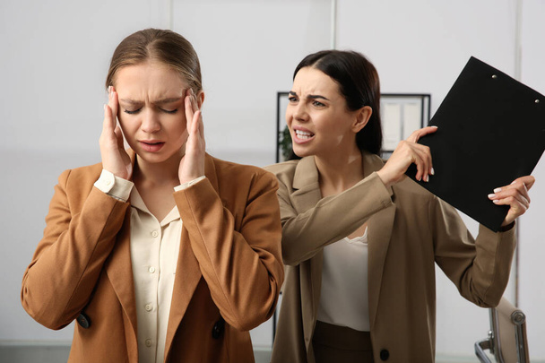 Boss screaming at employee in office. Toxic work environment - Photo, image