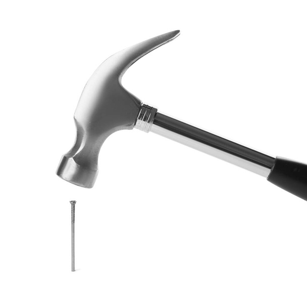 Hammer and metal nail on white background - Valokuva, kuva