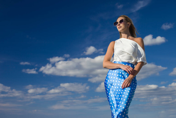 young slender woman by the sea posing in clothes - 写真・画像