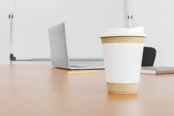 mockup of recycled cardboard mug on an office table with a laptop and whiteboard in the background blurred. 3d render - Zdjęcie, obraz