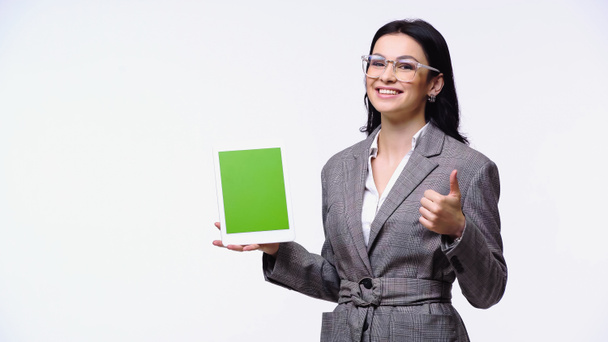Mujer de negocios sonriente mostrando como gesto mientras sostiene la tableta digital con croma clave aislada en blanco - Foto, imagen