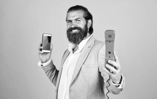 communication. true gentleman with groomed hair hold vintage telephone. nice conversation. bearded man in formalwear with modern and retro phone. elegant businessman has business talk - Foto, Imagem