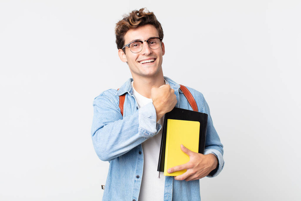 young handsome man feeling happy and facing a challenge or celebrating. university student concept - 写真・画像
