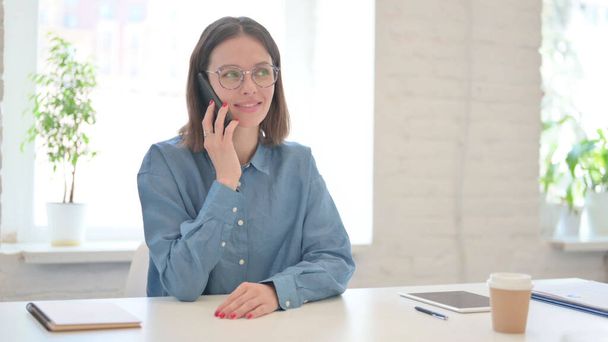 Woman Talking on Smartphone in Office  - Photo, Image