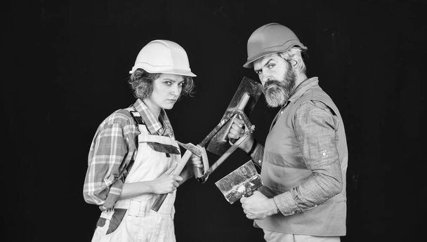 Couple renovating house. Woman builder hard hat. Man engineer or architect. Gender equality. Construction site. Quality inspector. Construction job occupation. Construction workers. Home renovation - Valokuva, kuva