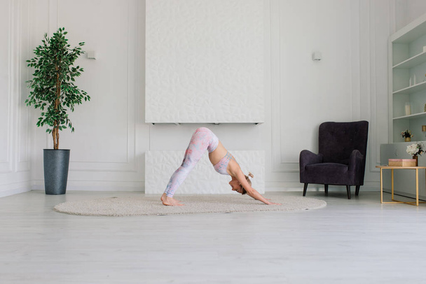Young woman meditating, doing yoga at home, back, front and side view - Photo, Image