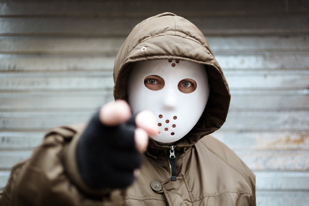 Anonymous man with plastic mask , criminal concept, selective focus on eye - Фото, изображение