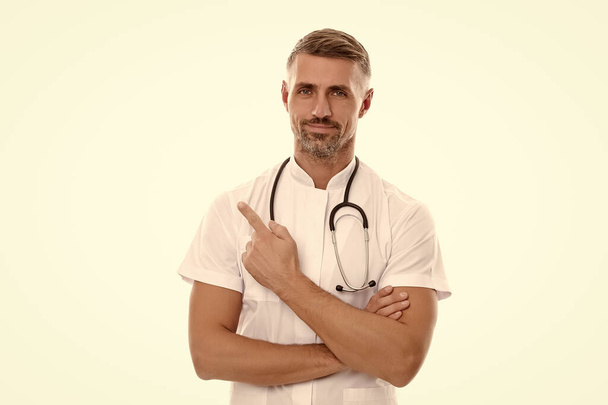 man family doctor or nurse with stethoscope isolated on white pointing finger, covid 19 - Foto, Bild