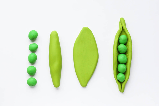 Modelling clay . Craft Plasticine Green Pea. Step by step. Childrens activity in school art lesson and plasticine concept. - Photo, Image