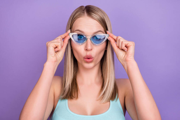 Photo of impressed blond young lady touch spectacles wear blue top eyewear isolated on violet color background - Фото, зображення