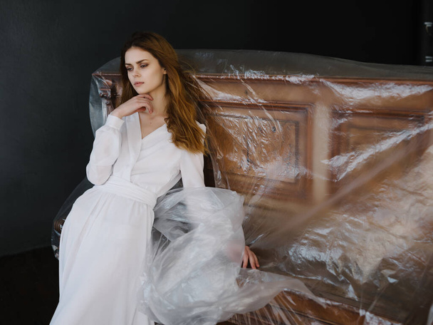 Woman in white dress near chained piano romance - Fotó, kép
