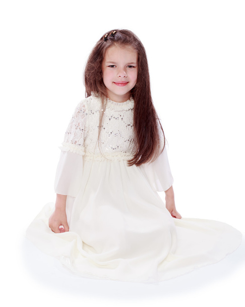 dark-haired little girl in a white dress - Фото, изображение