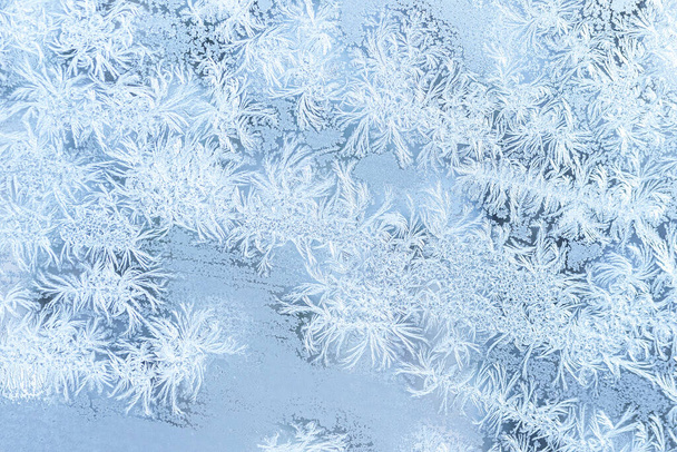 The texture of the glass covered with frost in winter in cold weather. Abstract natural background. - Photo, Image