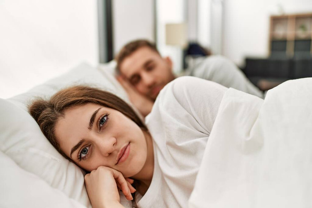Fiatal kaukázusi pár otthon alszik az ágyon. - Fotó, kép